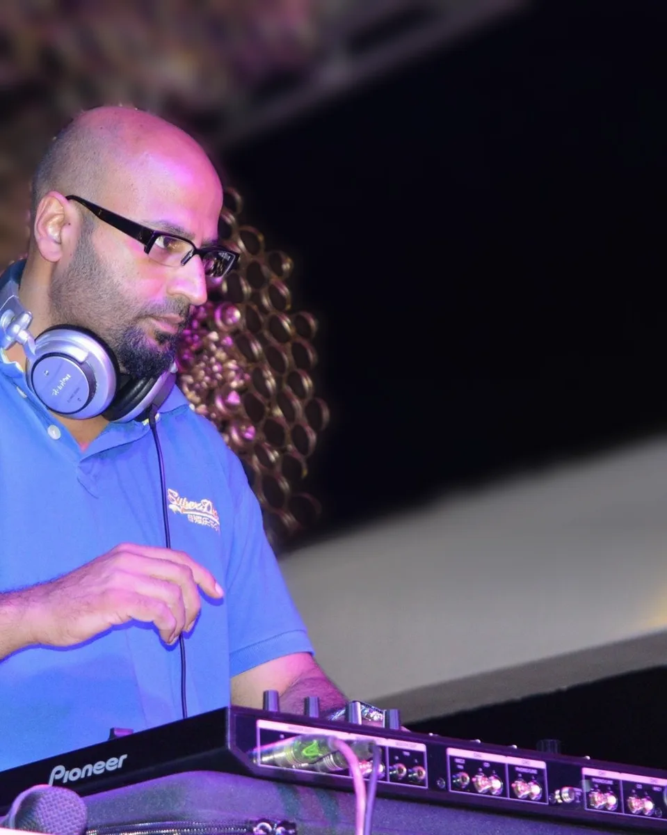 DJ RPM with headphones at the decks at a private party